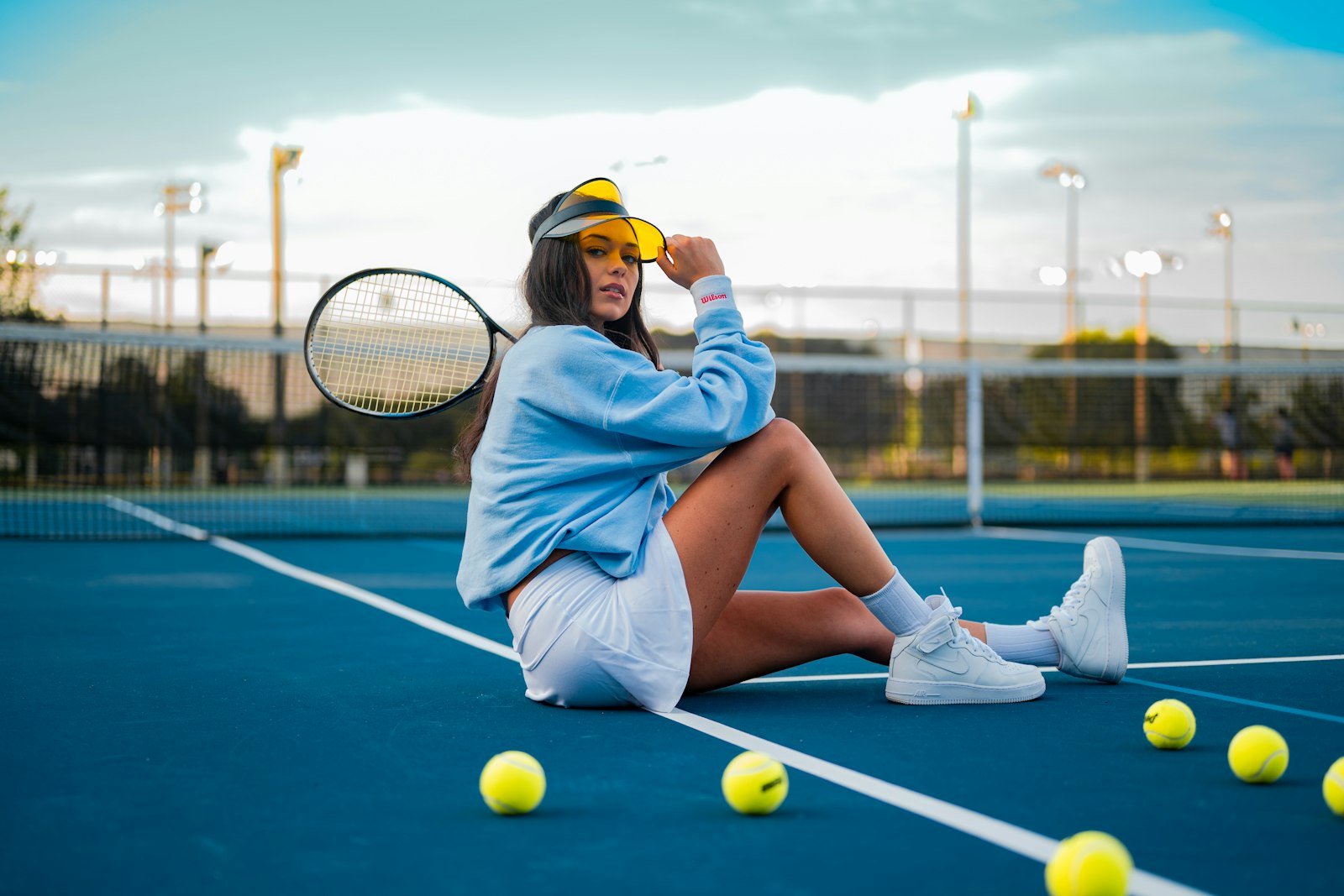 a player resting between games on a sunlit hard court