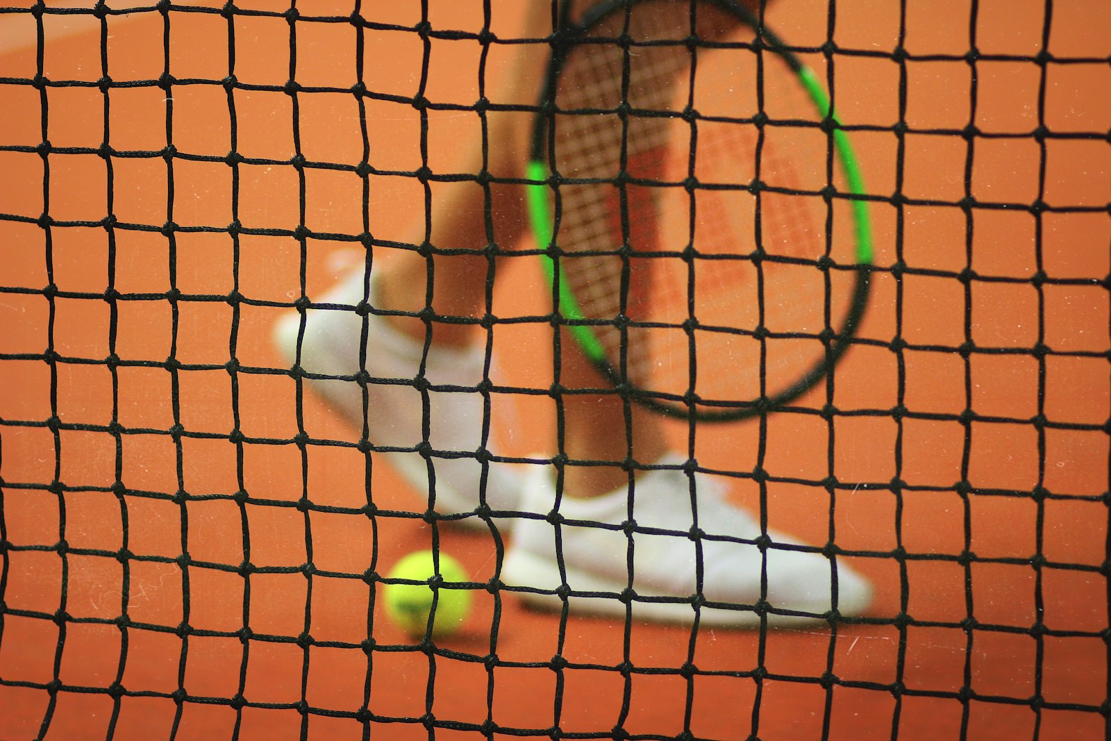 a tennis net and racket in close detail